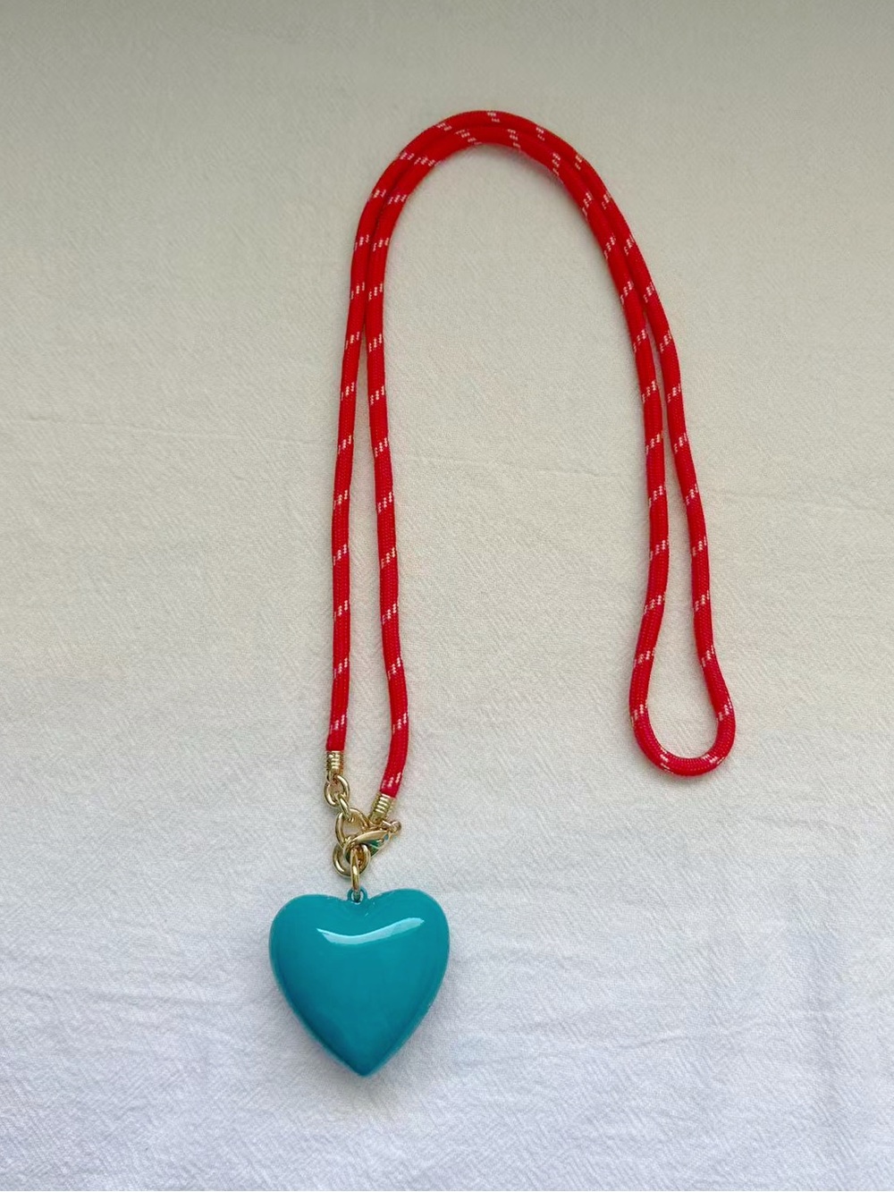 Roxanne Assoulin Long Happy
Cord Charm
Necklace Red Cord Dark Turquoise Charm - Picture 2 of 4